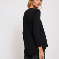 Person wearing a black outfit on a white background