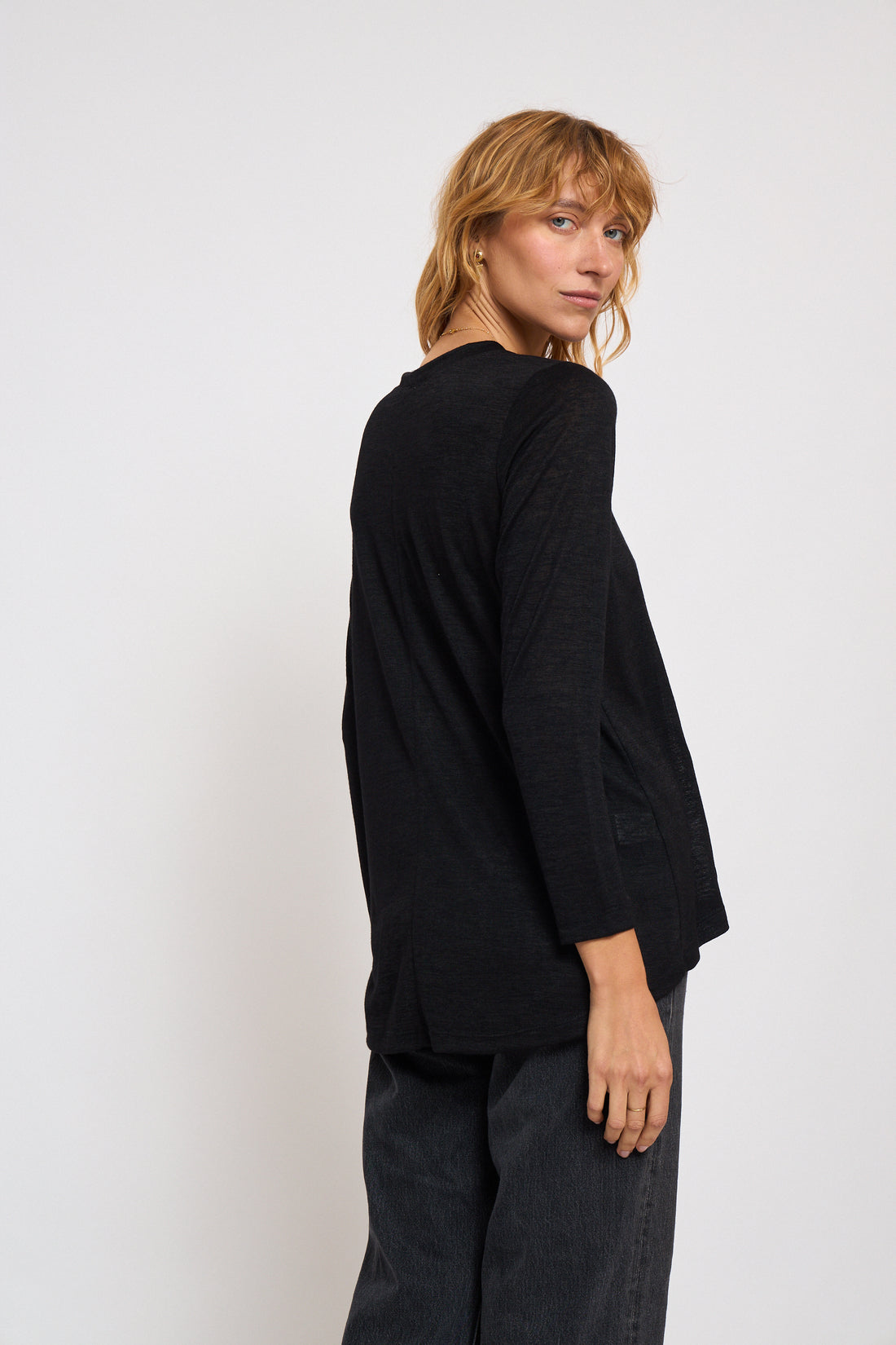 Person wearing a black outfit on a white background